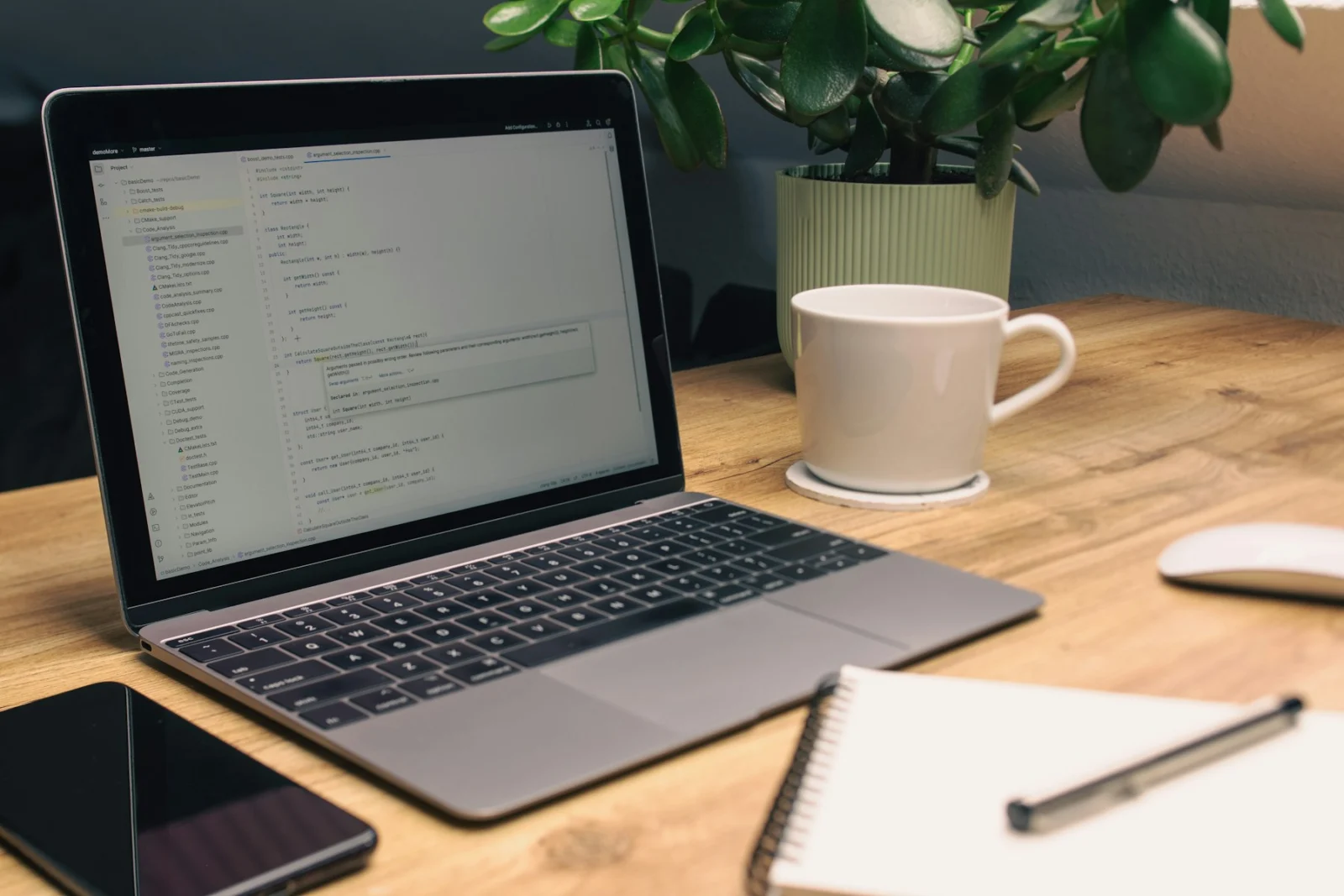 A developer’s desk with a laptop, notebook and coffee — the kind of workspace most StackNudge projects start from
